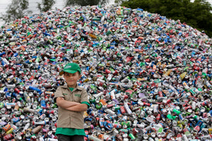 Ryan Hickman posing in front of recycling pile
